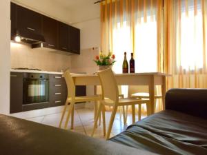 a kitchen with a table and chairs and a dining room at Settimo cielo in Rosolina Mare