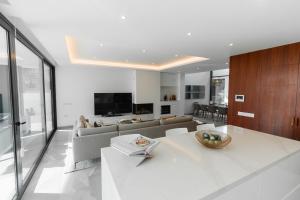 a living room with a couch and a table at Buganvilia - Luxury villa - private pool by HD in Almancil