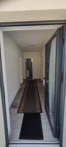 an empty hallway with a rug on the floor at Home Nikolić in Novi Pazar