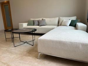 a living room with a couch and a table at Luxury apartment s2 in Sidi Daoud