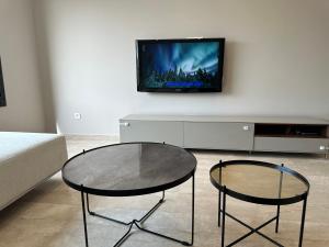 a living room with a table and two chairs and a tv at Luxury apartment s2 in Sidi Daoud
