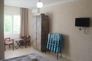 a living room with a cabinet and a tv at zaza in K'obulet'i