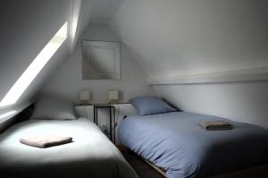 two beds sitting next to each other in a room at Petite vague - maison atypique avec terrasse in Saint-Aubin-sur-Mer