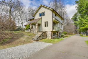 a large white house with a stone facade at Charming Greenwich Escape Near Wooded Trails! in Cos Cob