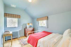 a bedroom with a bed and two windows at Charming Greenwich Escape Near Wooded Trails! in Cos Cob