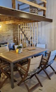 a wooden table with two chairs and a dining room at La Mata primera línea de playa in Torrevieja