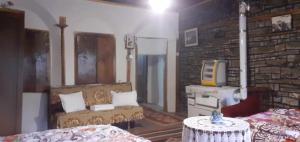 a room with two beds and a stone wall at guest house in buhal in Përmet