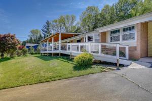 a large house with a porch and a yard at Lakefront Kingsport Home with Private Hot Tub! in Kingsport