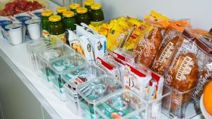 a counter with various food and drinks and snacks at Bonne Nuit Guest House in Azzano San Paolo