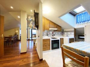 a kitchen and living room with a table and a dining room at Ca' Murazzi in Mestre