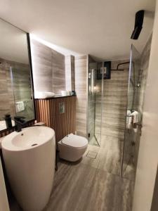 a bathroom with a sink and a toilet and a shower at Rita's 2-BR Apt in Mar Mikhael in Beirut