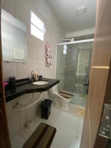 La salle de bains est pourvue d'un lavabo, de toilettes et d'une douche. dans l'établissement Pousada Vila das Lagoas, à Santo Amaro