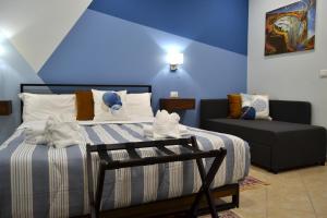 a blue room with a bed and a couch at Casa Grazia - Guest House - in Reggio Calabria