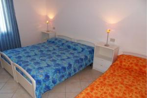 a small bedroom with a bed and two night stands at Settimo cielo in Rosolina Mare