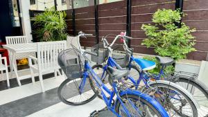 two bikes parked next to each other on a sidewalk at FRIENDS@SaiLom in Bangkok