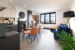 a kitchen and a living room with a table and chairs at 4 Beds 2 Bath Stunning Apartment On Street Parking in Brighton & Hove