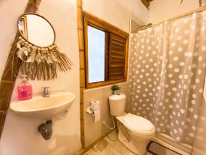 a bathroom with a sink and a toilet and a mirror at Rincon del Mar Palomino in Palomino +64 photos