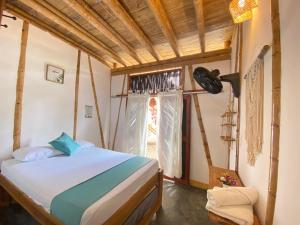 a bedroom with a bed and a window at Rincon del Mar Palomino in Palomino