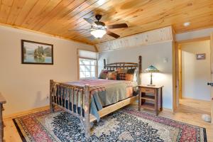 a bedroom with a bed and a ceiling fan at Lake George Vacation Rental - Walk to the Water! in Lake George