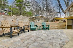 a patio with chairs and a table and a fence at Lake George Vacation Rental - Walk to the Water! in Lake George