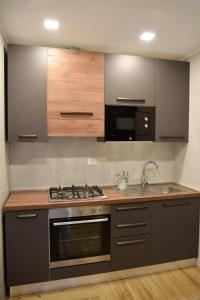 a kitchen with a stove and a sink at La Maison Latina Guest House in Latina