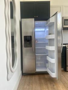 a refrigerator with its door open in a kitchen at Cloud II Los Angeles at Beverly Hills in Los Angeles