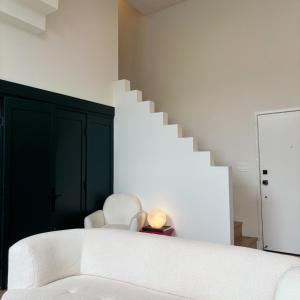 a living room with a white couch and stairs at Cloud II Los Angeles at Beverly Hills in Los Angeles
