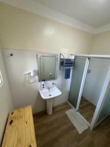 a bathroom with a sink and a shower at El Conde De Atrini in Santo Domingo