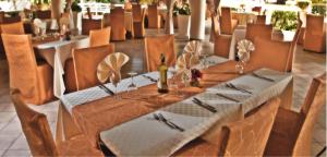 a dining room with a table with a bottle of wine at Mwembe Resort - The Village in Malindi