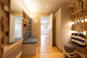 a hallway with a bench in the middle of a room at Seeblick Genuss und Spa Resort Amrum in Norddorf