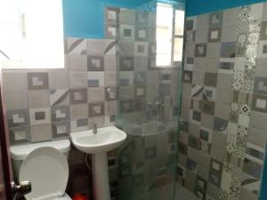 a bathroom with a sink and a toilet and a shower at Residencial espinal 2 in Punta Cana