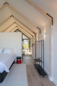 a bedroom with a bed and a large window at FONTE SANTA Manor House in Vila Nova de Gaia