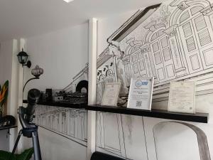 a shelf with a drawing of a building on it at Chino Town Gallery Alley - SHA Plus in Phuket Town