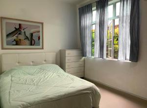 a bedroom with a bed and a window at Ideal Homestay Bayan Lepas in Bayan Lepas