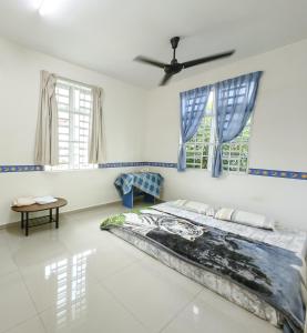 a bedroom with a bed and two windows at Ideal Homestay Bayan Lepas in Bayan Lepas