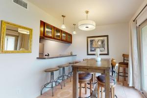 a dining room with a table and bar stools at Rockport Getaway #608 in Rockport