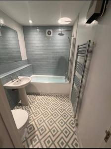 a bathroom with a sink and a toilet and a shower at Unique apartment in stunning Manor house in Potterne