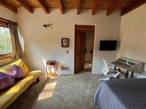 a bedroom with a couch and a desk and a table at Suite Fontana Baja in Valle de Bravo