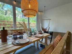 a dining room with a wooden table and a large window at Familienurlaub im Schwarzwald, Europapark-Nähe in Ettenheim
