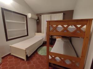 a small room with two bunk beds and a mirror at Chalet Del Lago in Termas de Río Hondo