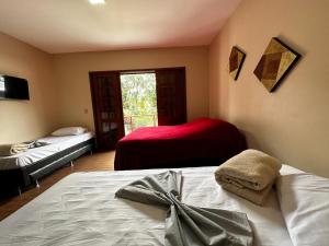 Una cama o camas en una habitación de Village Hostel