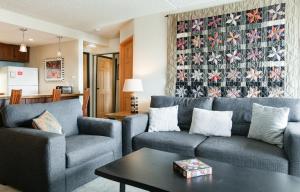 a living room with two couches and a table at Trails End Easy Rest Condo: Ski In/Out, Stroll To Main Street in Breckenridge
