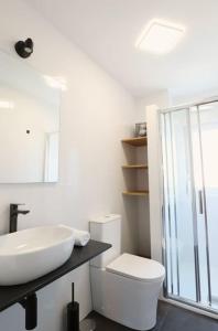a white bathroom with a sink and a toilet at Notel Club - Oasis urbano en Santander in Santander