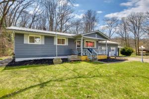 a small blue house with a yard at Cozy DuBois Home with Deck about 8 Mi to Treasure Lake! in DuBois