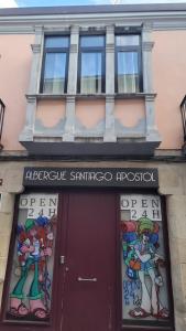 a building with a sign above a door at Albergue Santiago Apostol in Logroño