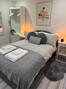 a bedroom with a bed with two pillows on it at Luxury 2 bedroom apartment in Belper