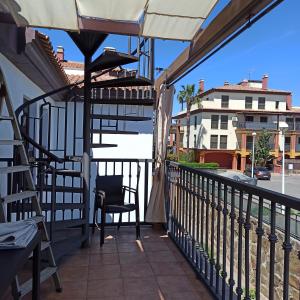 a balcony with a chair and a view of a street at La Colina Playa&Golf in Huelva +41 photos