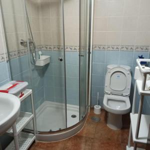 a bathroom with a shower and a toilet and a sink at La Colina Playa&Golf in Huelva