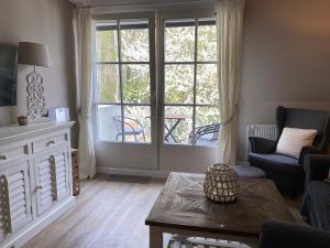 a living room with a large window and a table at Strandappartment Meerkieker in Travemünde