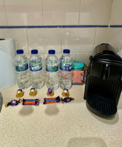 a group of bottles of water sitting on a counter at Victoria - 1 bedroom appartment 4 people in London